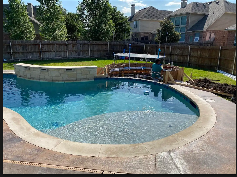 New pool construction in Austin featuring custom tiling and coping